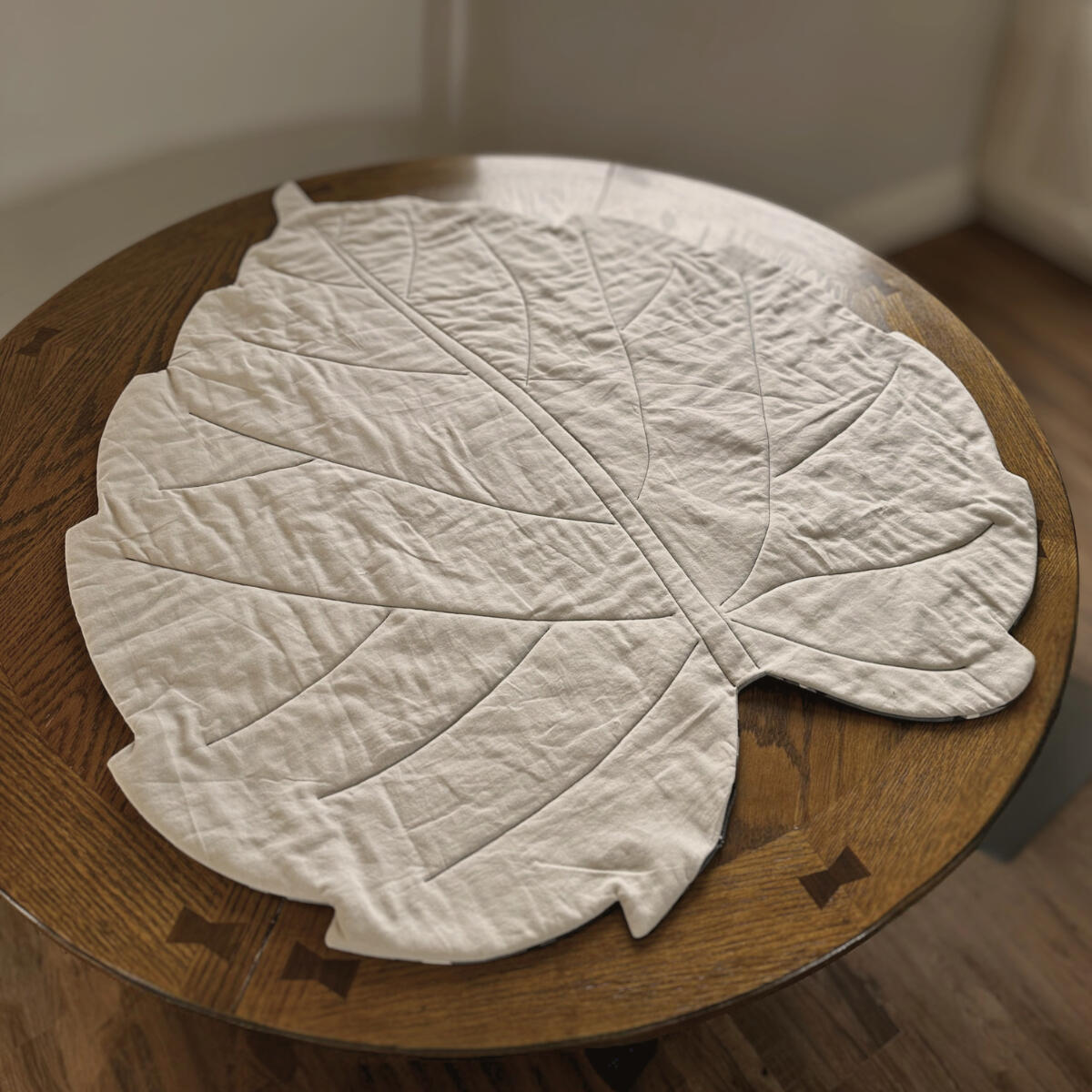 Quilted Leaf Blanket displayed on a table